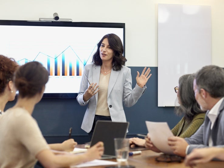A female executive giving a presentation at a business meeting.